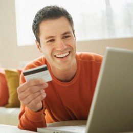 Man using credit card to make online purchase